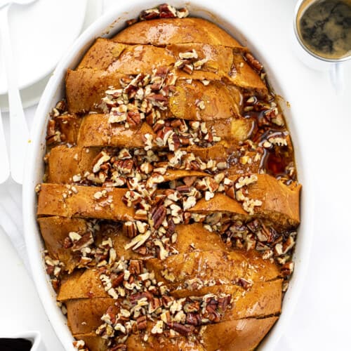 Pumpkin French Toast Casserole in a White Casserole Dish on a Counter with Espresso.
