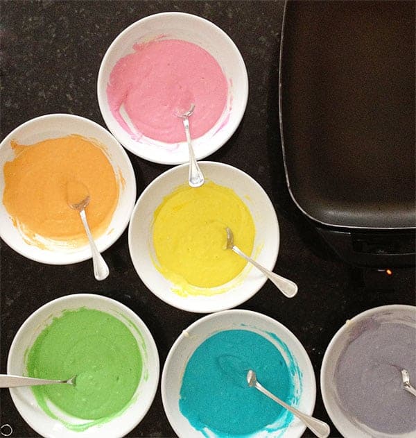 These colorful pancakes look like the rainbow and taste delicious! All you need is some food coloring and the best pancake recipes to start your day with some beauty! Tips on how to make the Perfect Rainbow Pancakes! #pancakes #rainbow