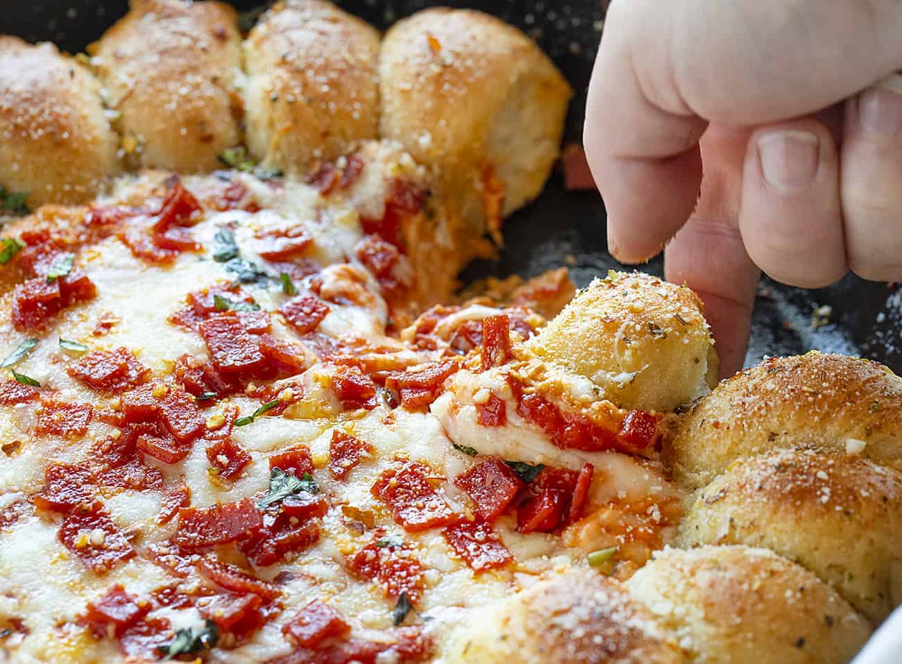 Skillet Pizza Dip combines the deliciousness of garlic bread with a cheesy, pepperoni dip. skillet pizza dip, iambaker, skillet dip, pizza dip, garlic rolls, appetizer, game day appetizer, pizza, dips Piece of Skillet Pizza Dip