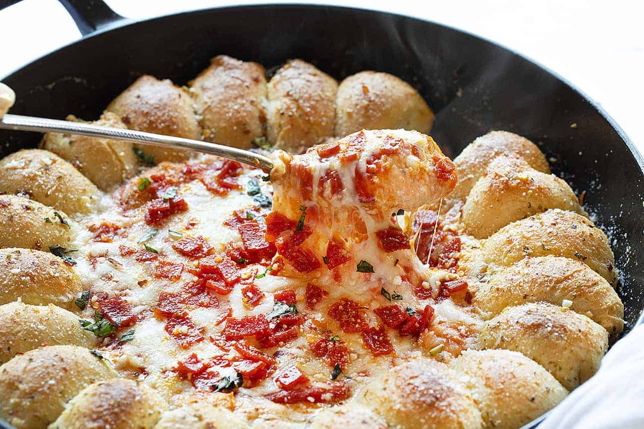 Skillet Pizza Dip combines the deliciousness of garlic bread with a cheesy, pepperoni dip. skillet pizza dip, iambaker, skillet dip, pizza dip, garlic rolls, appetizer, game day appetizer, pizza, dips Spoonful of Skillet Pizza Dip