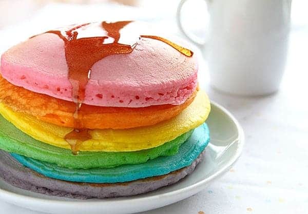 These colorful pancakes look like the rainbow and taste delicious! All you need is some food coloring and the best pancake recipes to start your day with some beauty! Tips for the Perfect Rainbow Pancake! #pancakes #rainbow