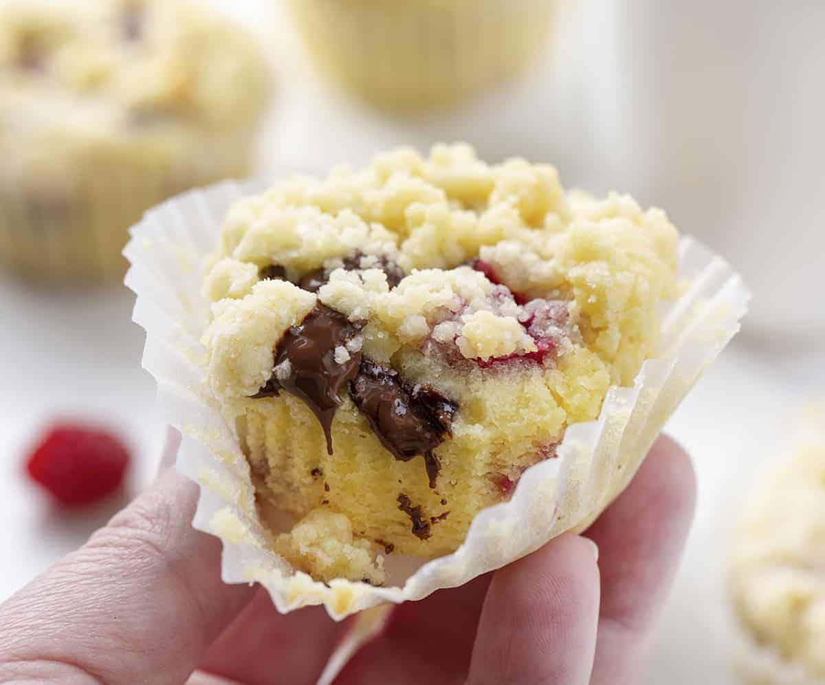 Raspberry Chocolate Muffins are cream cheese muffins loaded with chocolate chunks and fresh raspberries, topped with a buttery crumb topping. Melt in your mouth deliciousness!! Muffins, Bakery Style Muffins, Raspberry Chocolate Muffins, Best Muffins, Muffin Recipes, Raspberry Muffins, Chocolate Muffins, i am baker, iambaker, baking, recipes Hand Holding Raspberry Chocolate Muffins Recipe