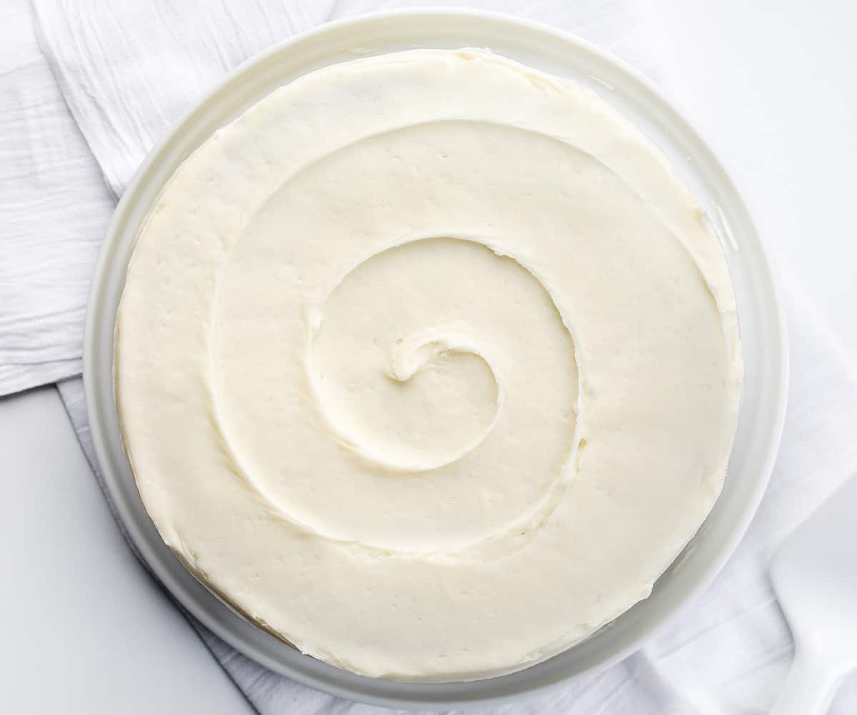The perfect Red Velvet cake has a rich, deep flavor and a color to match! Then paired with the perfect cream cheese frosting, this just might be the perfect cake! Top of a red velvet cake with the cream cheese frosting swirled.