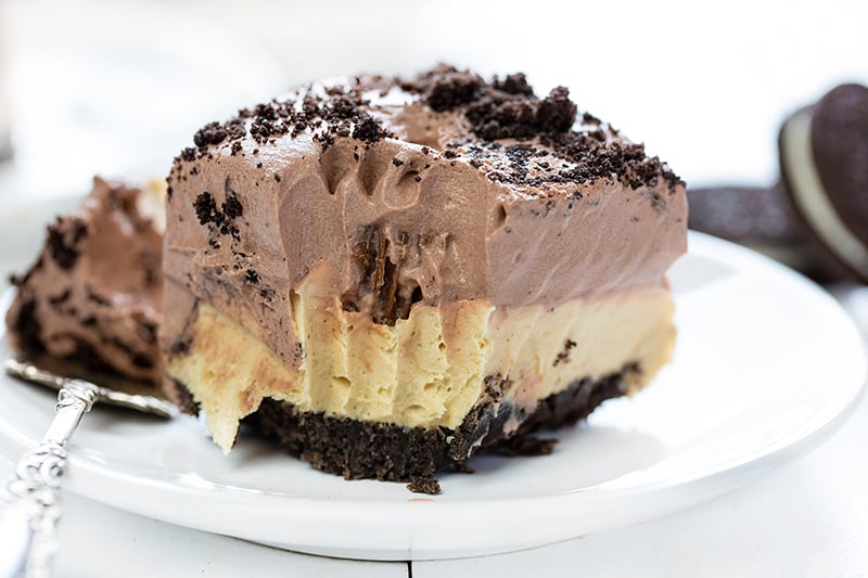The best no-bake desserts to get your sweet tooth through the summer! no bake, no bake desserts, desserts, recipes, cheesecake, cookies, bars, cake, pudding, mousse, puppy chow, muddie buddies, rice krispy bars, dessert, memorial day dessert, labor day desserts, i am baker, iambaker Plate of Peanut Butter Oreo Dessert.