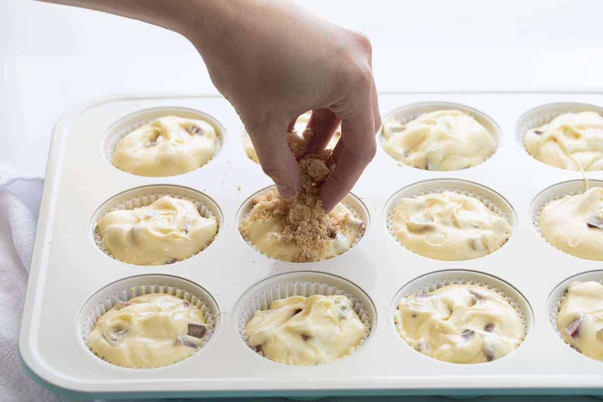 Rhubarb Streusel Muffins are made with cream cheese in the batter for a super moist muffin, with added rhubarb and a streusel topping. Rhubarb Recipes, Baking with Rhubarb, Rhubarb Muffins, Muffin Recipes, Baking, Breakfast, Summer Recipes, i am baker, iambaker Adding Streusel to Rhubarb Muffins.