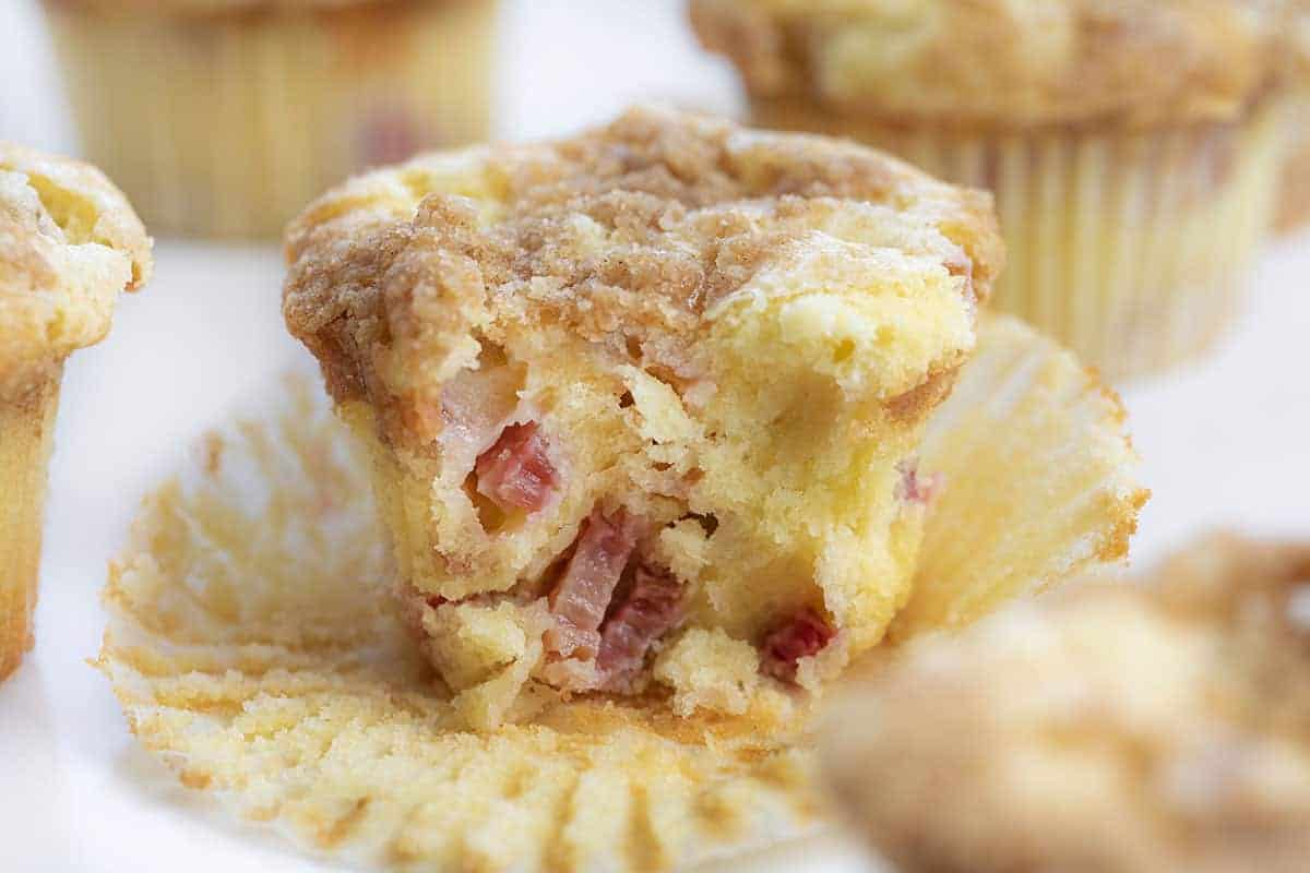 Rhubarb Streusel Muffins are made with cream cheese in the batter for a super moist muffin, with added rhubarb and a streusel topping. Rhubarb Recipes, Baking with Rhubarb, Rhubarb Muffins, Muffin Recipes, Baking, Breakfast, Summer Recipes, i am baker, iambaker Bit Into Rhubarb Streusel Muffins.