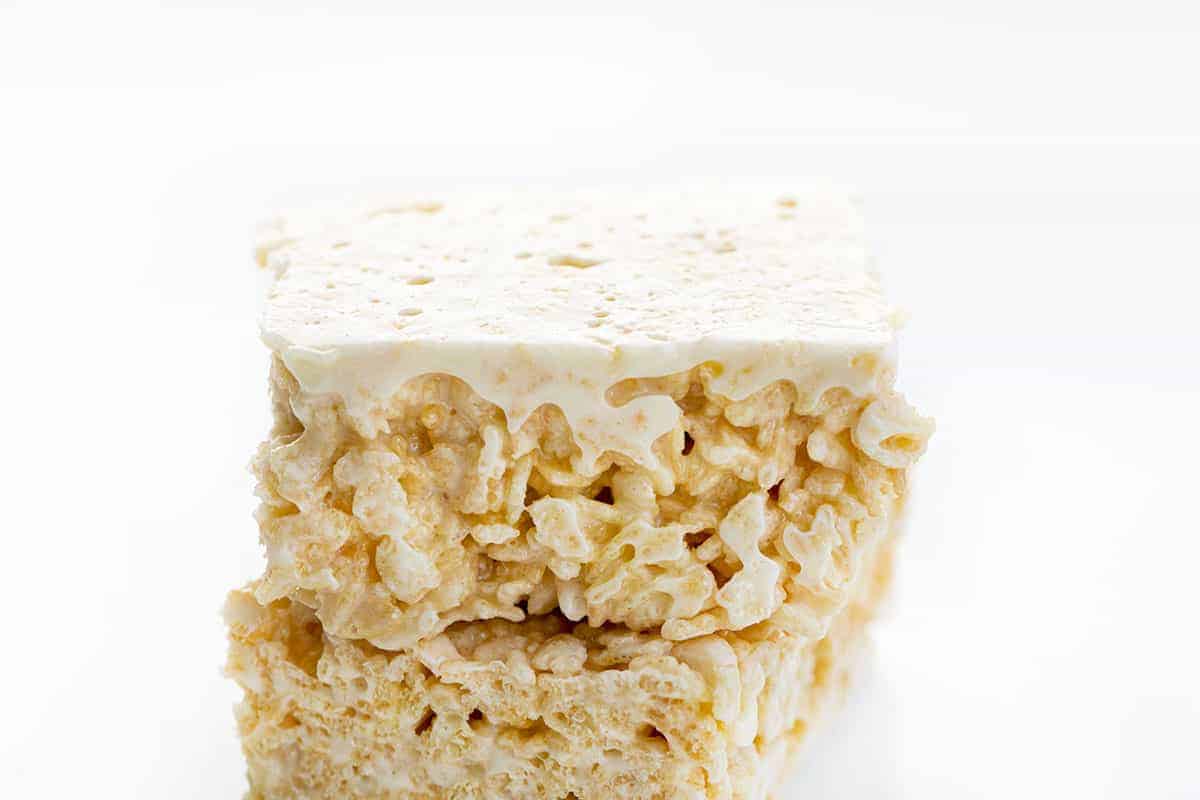 The best no-bake desserts to get your sweet tooth through the summer! no bake, no bake desserts, desserts, recipes, cheesecake, cookies, bars, cake, pudding, mousse, puppy chow, muddie buddies, rice krispy bars, dessert, memorial day dessert, labor day desserts, i am baker, iambaker Viral Rice Krispie Bars Stacked with One Upside Down.