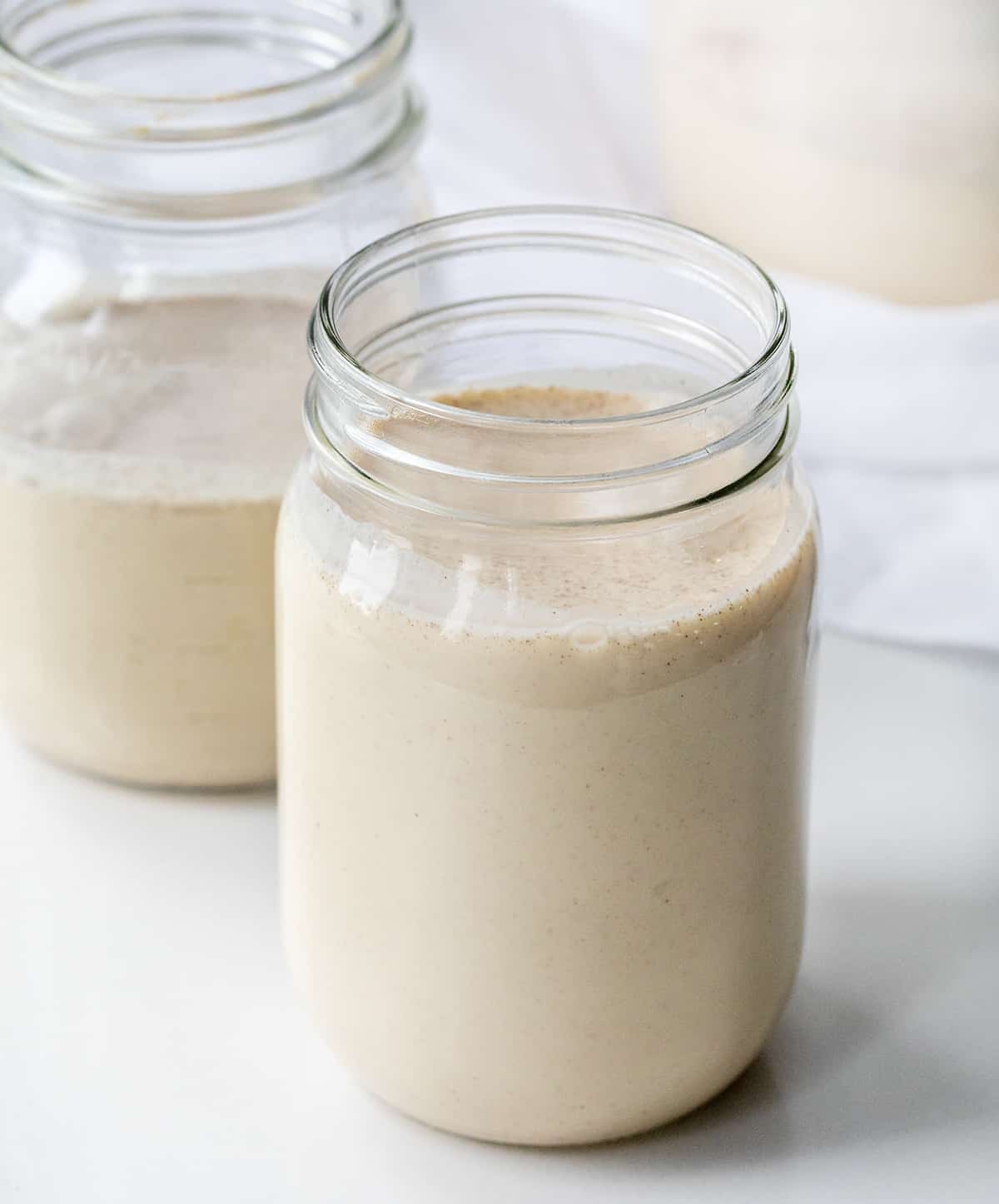 If you love a smooth, creamy cocktail... this is the recipe for you! RumChata is described as a Caribbean rum that blends with Mexican spices and cream. It is the perfect addition to many cocktails and smart to have on hand during the holidays! Perfect for Christmas Cocktails, New Years Eve Cocktails, or even your company Christmas Party! Canning jar filled with homemade RumChata.
