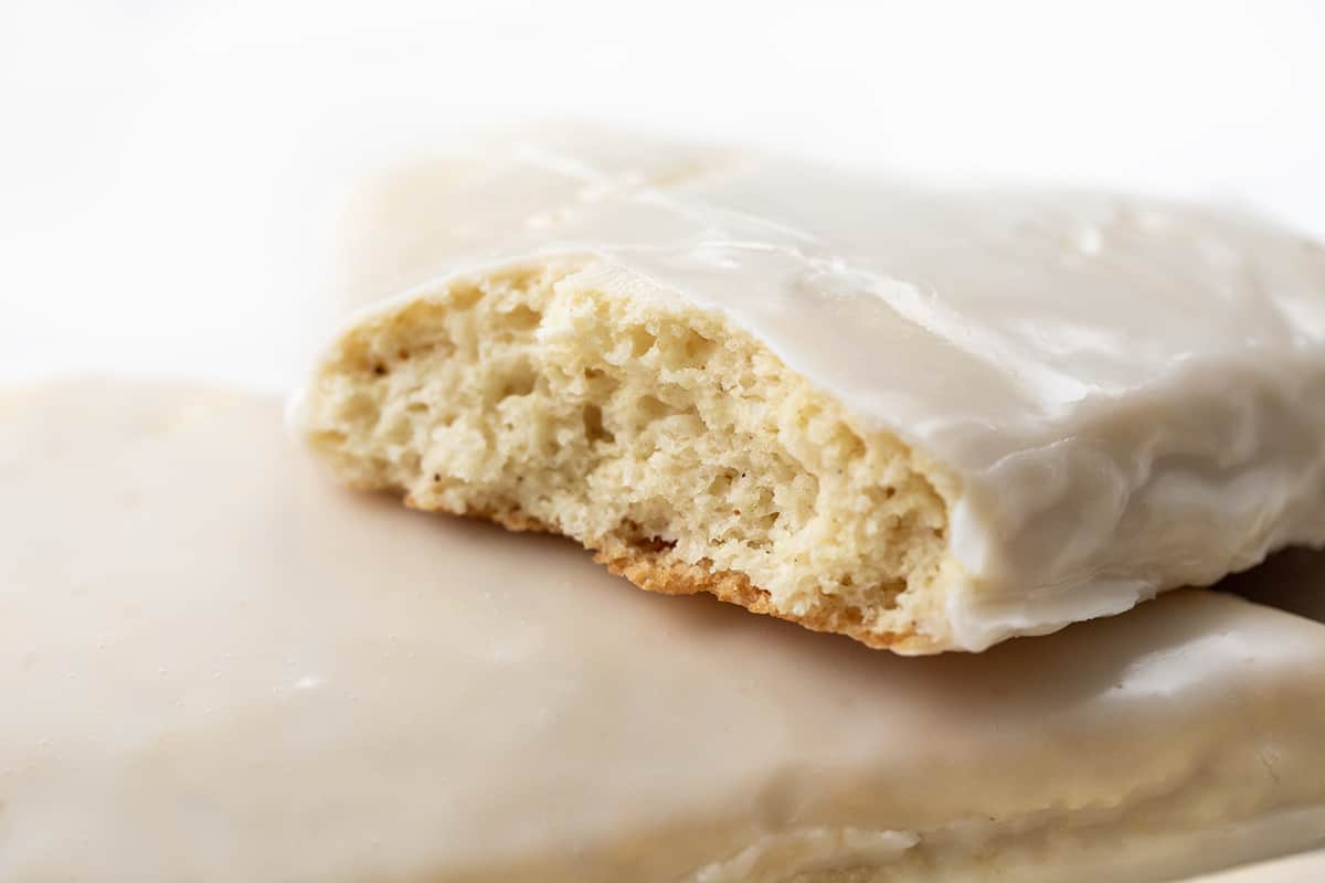 My sconut recipe will give you the perfect texture of a scone with the irresistible flavor of a doughnut, all in one bite! Plus, the best part? They're baked in the oven, not fried, making them a healthier option. Whether you can't decide between a scone or a doughnut or simply love both, this recipe is a must-try for all scone and doughnut lovers! Broken Sconut Showing the Inside Texture.
