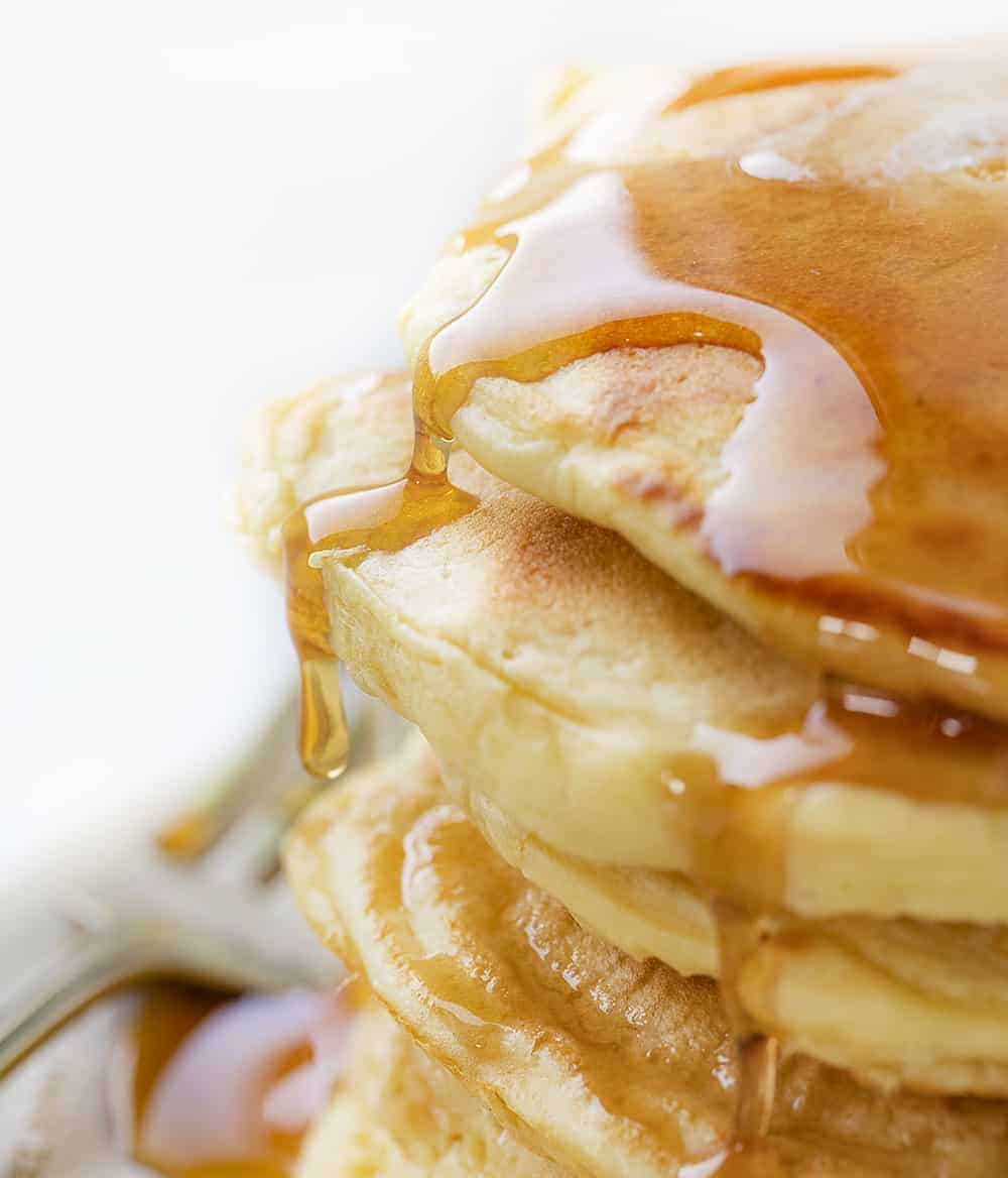 Using your sourdough starter, you can have light and fluffy Sourdough Pancakes ready to serve for a breakfast that will have everyone jumping out of bed! Breakfast, Pancakes, Sourdough Pancakes, How to Make Pancakes with Sourdough Discard, Sourdough Starter, The Best Pancakes, Sourdough Pancakes Recipe, i am baker, iambaker, pancakes Close Up of Syrup Spilling over Stacked Sourdough Pancakes