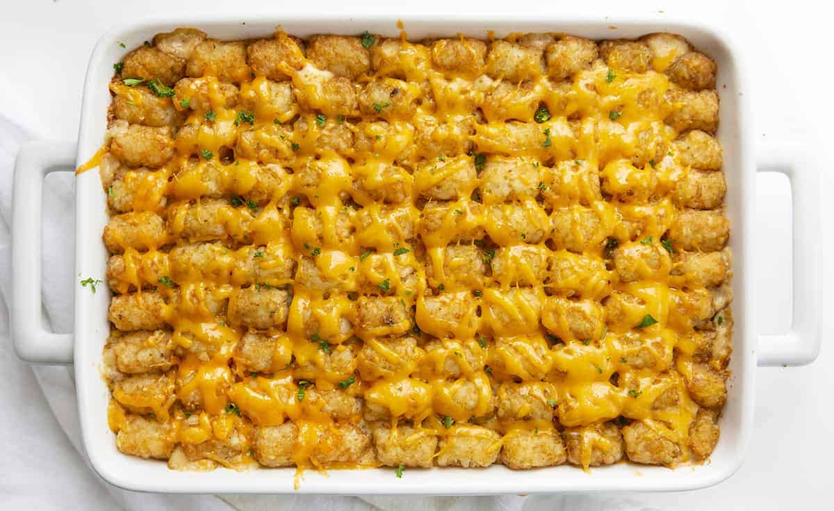 Overhead of Tater Tot Hotdish in White Casserole Pan with White Towel