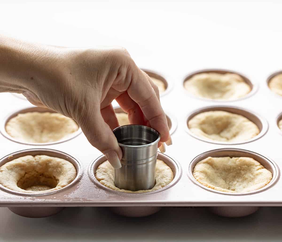Turtle Cookie Cups are a heavenly combination of soft and chewy cookies, homemade caramel, rich chocolate ganache, crunchy pecans, and a hint of salt. They are a delightfully indulgent treat made with the classic flavors of a turtle dessert in a cookie cup that is baked in a muffin tin. Making Cookie Cups to Make Turtle Cookie Cups.