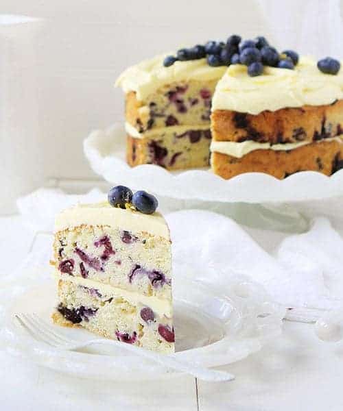 THIS is the dessert of the summer! Perfect infusion of lemon and blueberry and my secret ingredient that makes it over-the-top moist! #iambaker #lemoncake #lemonblueberrycake #baking #summer #desserts #bbq Lemon Blueberry Cake with Lemon Buttercream