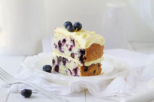 THIS is the dessert of the summer! Perfect infusion of lemon and blueberry and my secret ingredient that makes it over-the-top moist! #iambaker #lemoncake #lemonblueberrycake #baking #summer #desserts #bbq Blueberry Zucchini Cake with Lemon Buttercream
